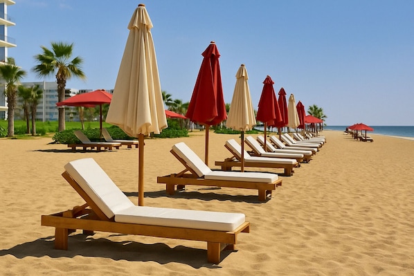 A beach with rows of sun loungers and alternating red and white umbrellas.