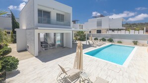 A modern two-story house with a swimming pool, outdoor seating, and a covered patio area. - Protaras Holiday Villa Ccv4 (Paralimni)