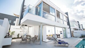 A modern two-story house with a balcony, a dining area, and a pool. - Protaras Holiday Villa Bp3 (Paralimni)