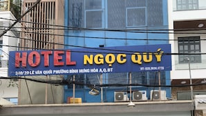 Een hotel met een blauwe gevel en een bord waarop 