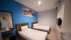 A hotel room with two single beds, a bathroom with a mirror and towel rack, a shelf with toiletries, and a wall-mounted TV. - Golden Pearl Hotel Near Universiti Tun Hussein Onn Malaysia UTHM (Batu Pahat)