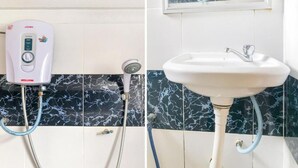 A bathroom with a white showerhead, a white sink, and a JOVEN water heater. - Madani Hotel Cameron Highland (Tanah Rata)