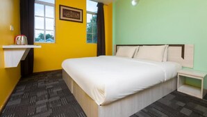 A hotel room with a bed, a nightstand, a window with curtains, and a wall with a framed picture. - Madani Hotel Cameron Highland (Tanah Rata)