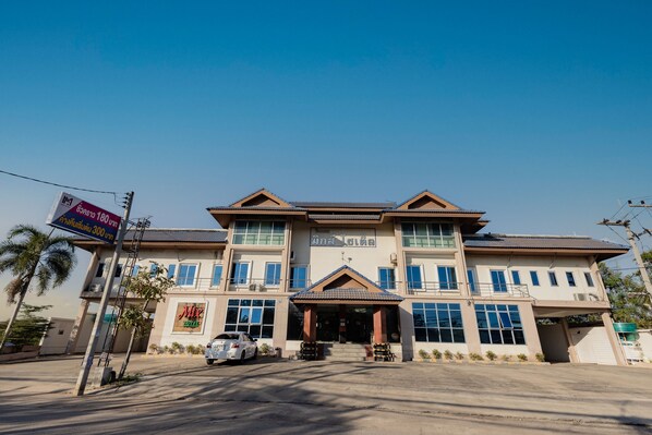 A two-story building with a sign indicating it is a hotel.
