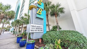 A hotel sign with 'Sandy Beach Oceanfront' and a vacancy sign for 1-2-3 bedrooms. - Direct Oceanfront View Suite,Pools at Sandy Beach! (Myrtle Beach)
