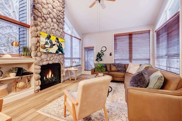 Living Room: Gather 'round the fire and enjoy modern comforts with stunning views of the snow!