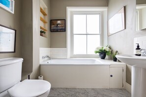 Bathtub, hair dryer, towels, soap