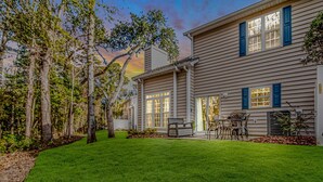 A two-story house with a covered patio and a lawn. - Discount! Walk to Beach, Golf,  Pool, Arcade, Beautiful and peaceful community (North Myrtle Beach)