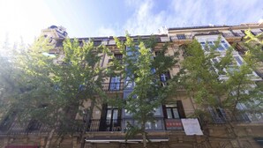 A multi-story building with balconies, windows, and a red awning. - San Martin - The Rentals Collection (San Sebastián)