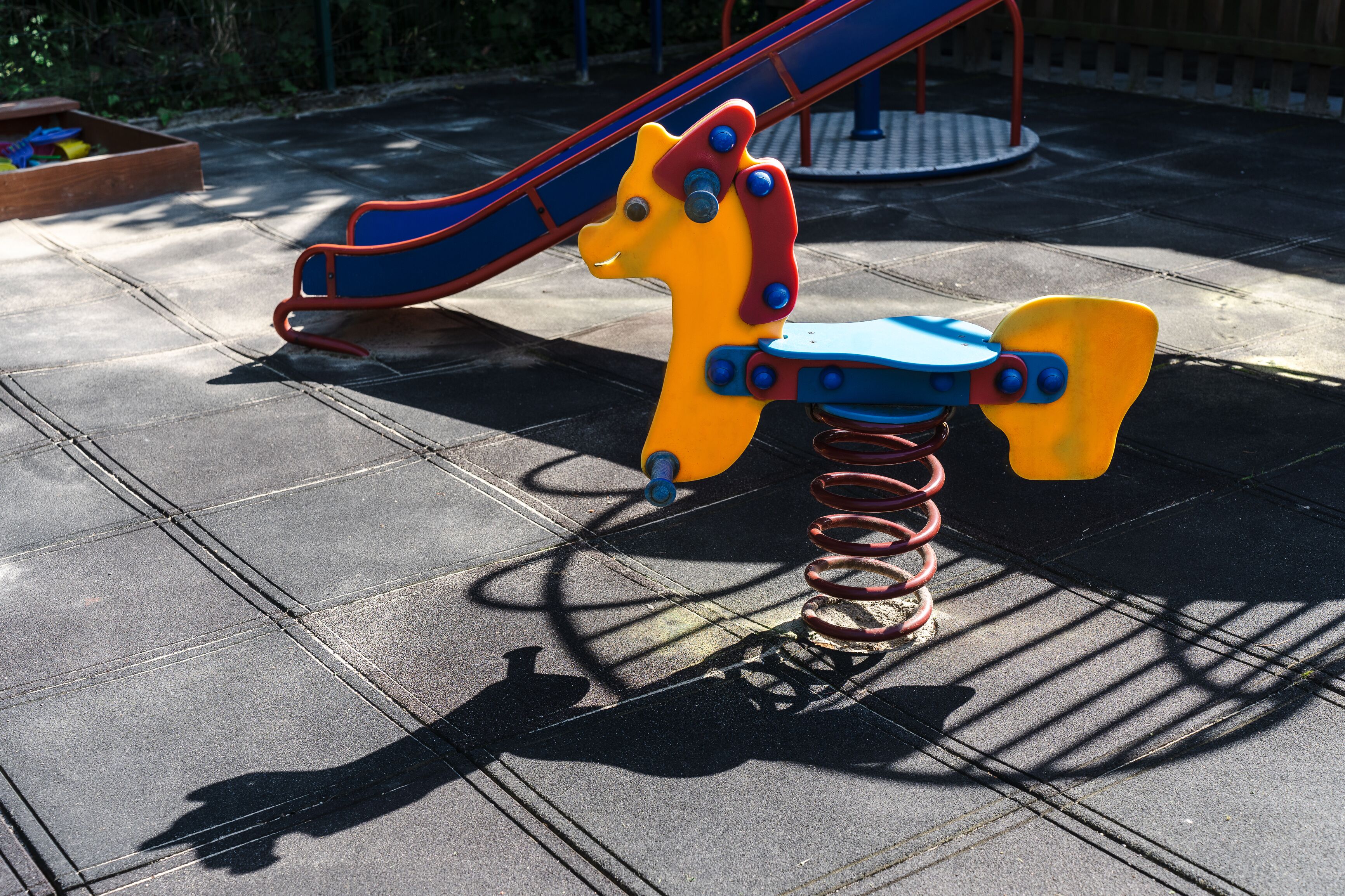 A playground with a slide and a swing set.
