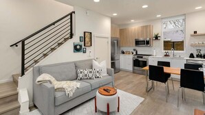 A modern kitchen with a built-in oven, microwave, and refrigerator. - Stylish & cozy home w/ rooftop, space needle view! (Seattle)