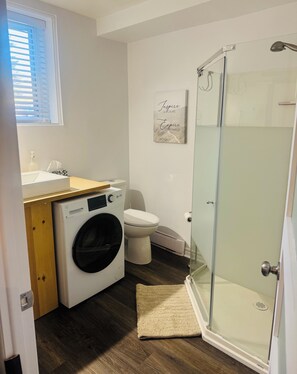 Shower, hair dryer, towels, toilet paper