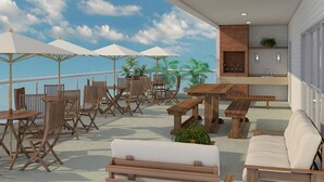 An outdoor patio with wooden furniture, white umbrellas, and a view of the ocean. - Santos Linda !! 5 min from the beach ! (SP)