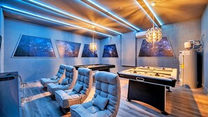 A room with a pool table, two lounge chairs, and wall-mounted starry sky artwork. - Star Wars Themed Game Room • Private Pool • Lazy River • Resort • Near Disney (Davenport)