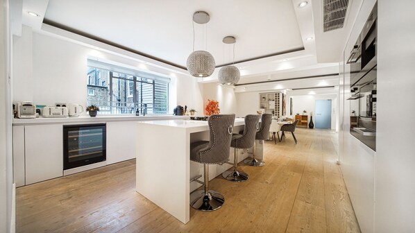 Prepare meals and dine in comfort at this kitchen with a central island and bar stools.
