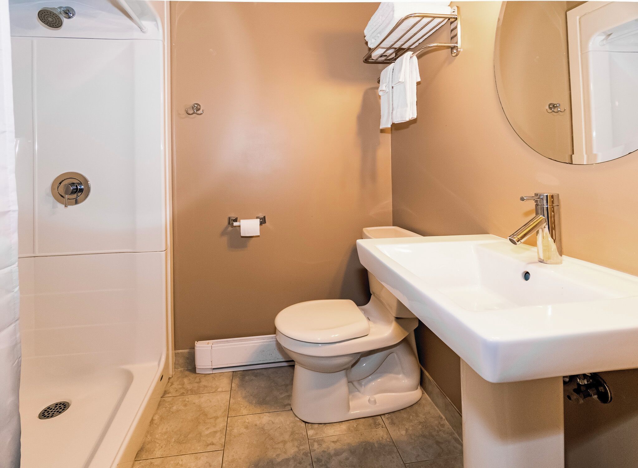 Un baño con ducha, inodoro y lavamanos.