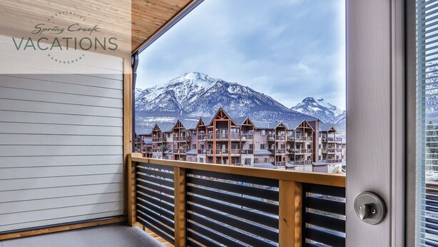 En balkon med udsigt over et bjerg og en række bygninger.