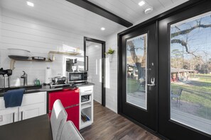 Enjoy cooking in this well-equipped kitchen with a large window offering a view of the outdoors.