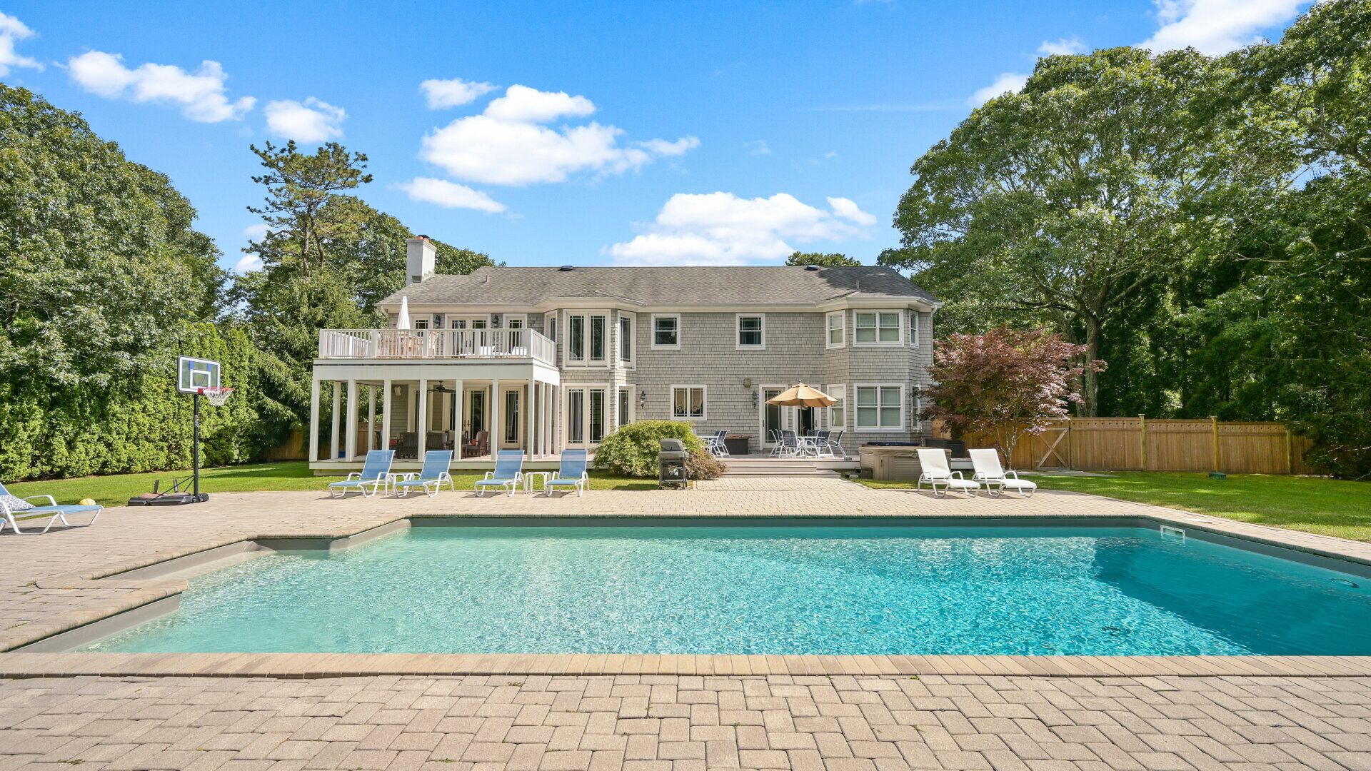 Exceptional shingle-style home sited on just under an acre of land,...