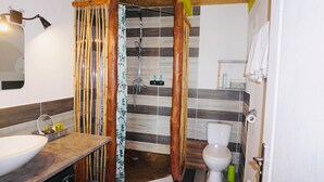 A bathroom with a shower, toilet, and sink.