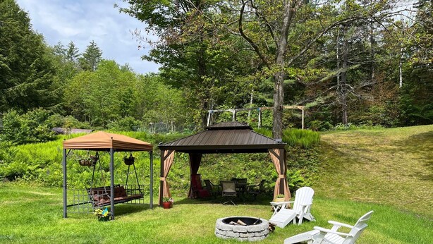 A gazebo with a swing set, a fire pit, and outdoor seating. - Vermont Retreat (Bridgewater)