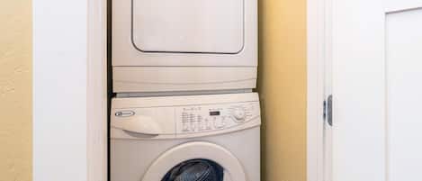 A front-loading washing machine with a control panel and a door.