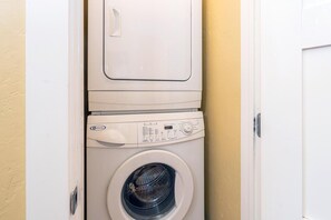 A front-loading washing machine with a control panel and a door.