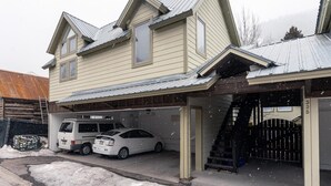 A two-story house with a garage, a van, and a car parked in front. - Charming Downtown Telluride Retreat | Walk to Main Street, Gondola & Lift 7 (Telluride)
