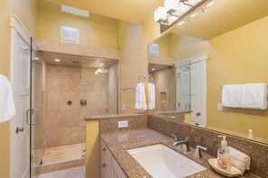 A bathroom with a glass-enclosed shower, a sink, and a mirror. - Columbine E 1 Bedroom with Loft (Telluride)