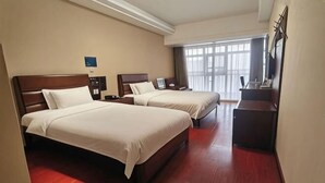 A hotel room with two beds, a desk, a nightstand, and a large window. - Puyuan Qihonglou Hotel (Tongxiang)