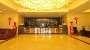 A lobby with a large, ornate chandelier, a reception desk, and red decorative vases. - Chongzhou Lanfeng Hotel (Chongzhou)