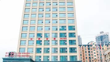 A multi-story building with a grid of windows and a flat facade.
