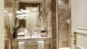 A bathroom with a marble vanity, a mirror, a sink, a shower, and a potted plant. - 2-nights accommodation at 1-Bedroom Executive Residence in London (London)