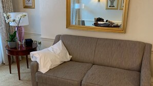 A living room with a brown sofa, a glass coffee table, a lamp, and a mirror. - 2-nights accommodation at 1-Bedroom Executive Residence in London (London)