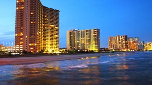 A beachfront hotel with multiple high-rise buildings, a sandy beach, and a calm sea. - Royale Palms 1204 2 Br Oceanview in Kingston, Pool (Myrtle Beach)