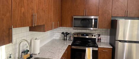 Microwave, dishwasher, coffee/tea maker, cookware/dishes/utensils