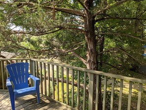 A wooden deck with a blue chair and a large tree. - DOUBLE DECKER CONDO! LARGE GROUPS! NEXT TO CAMPUS! (Oxford)
