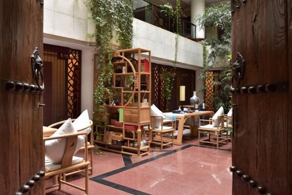 A spacious indoor area with wooden furniture and a central wooden structure, possibly a bookshelf or display unit. - Beijing Post & Telecom Conference Centre (Beijing)