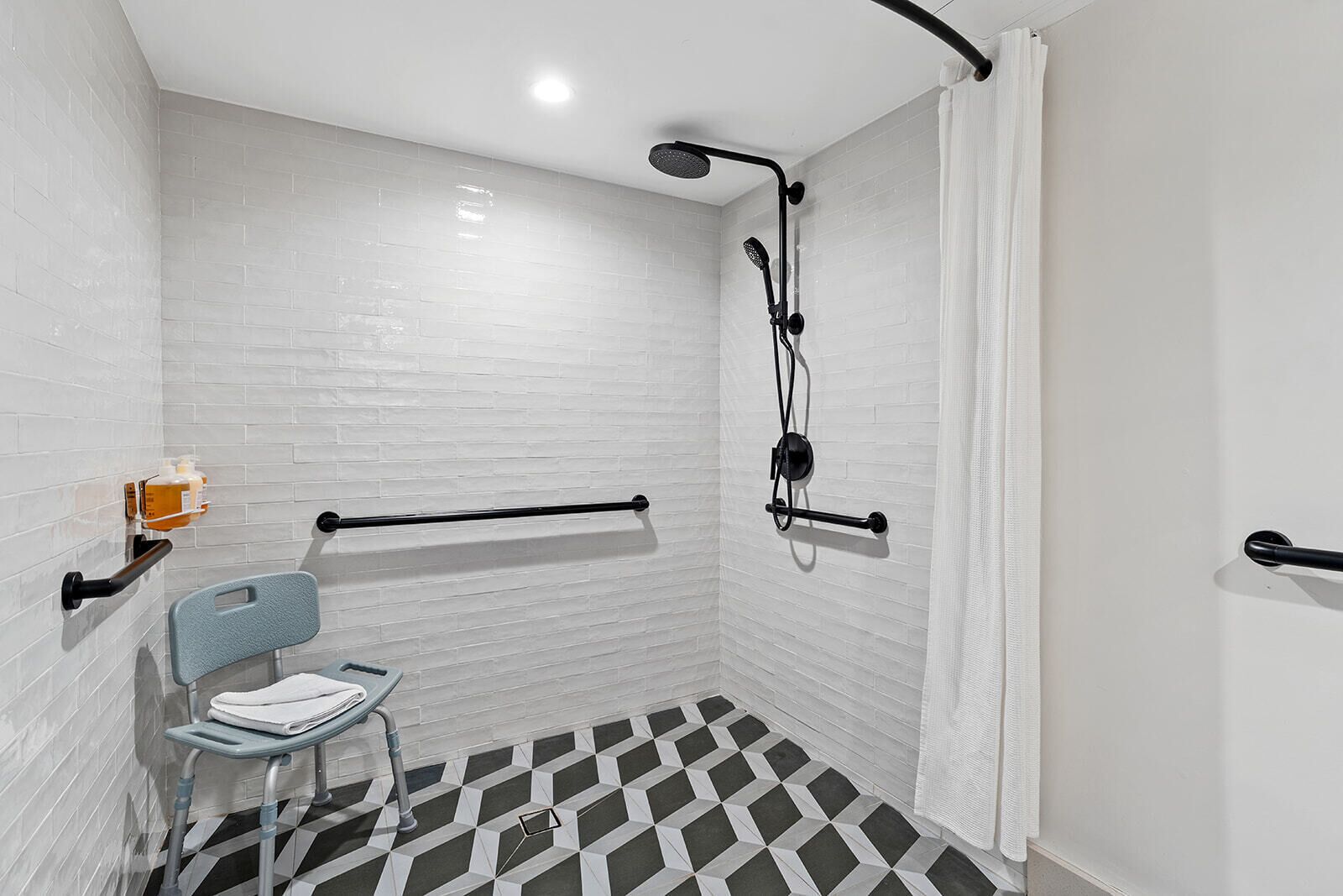 Shower, designer toiletries, hair dryer, towels