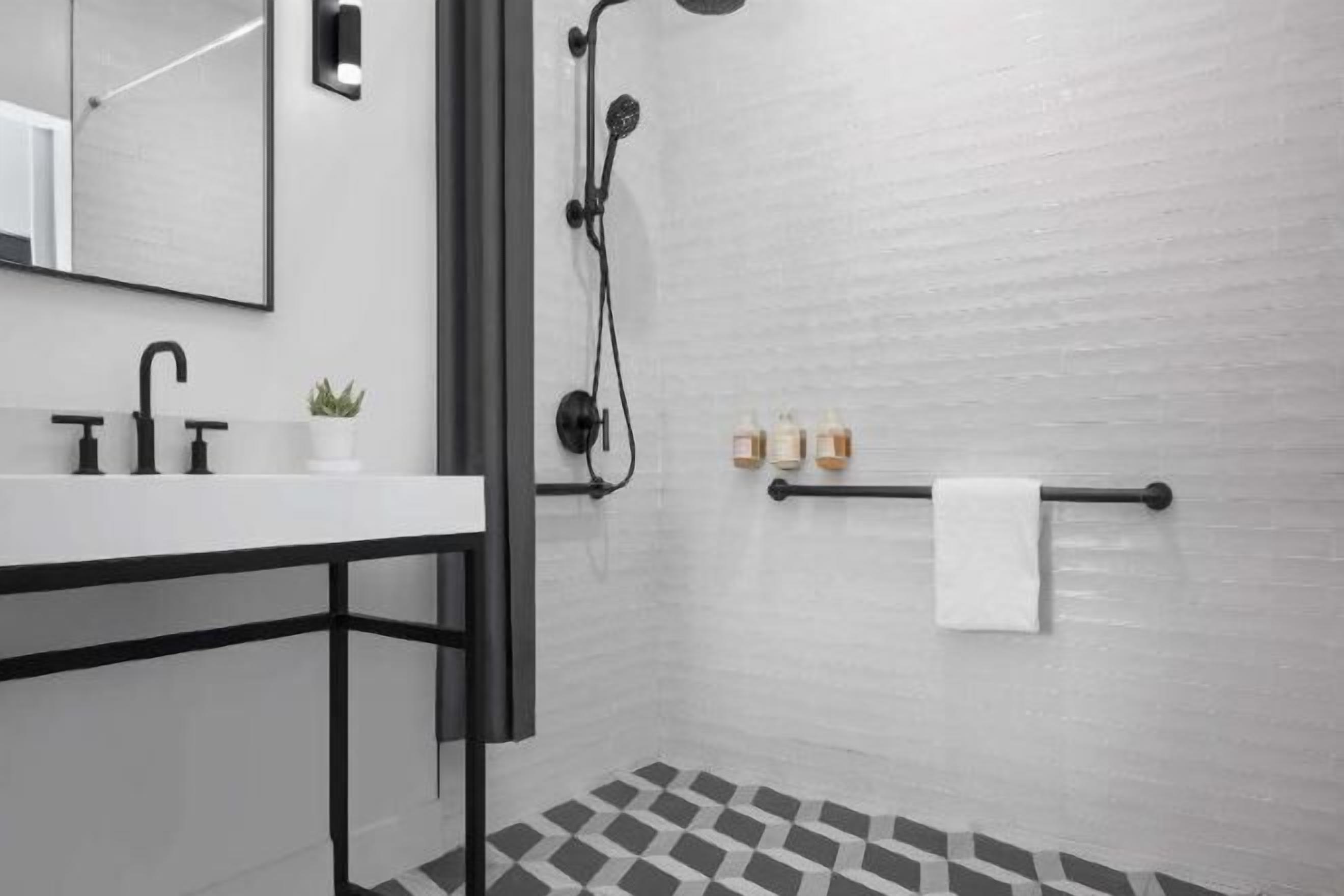 Shower, designer toiletries, hair dryer, towels