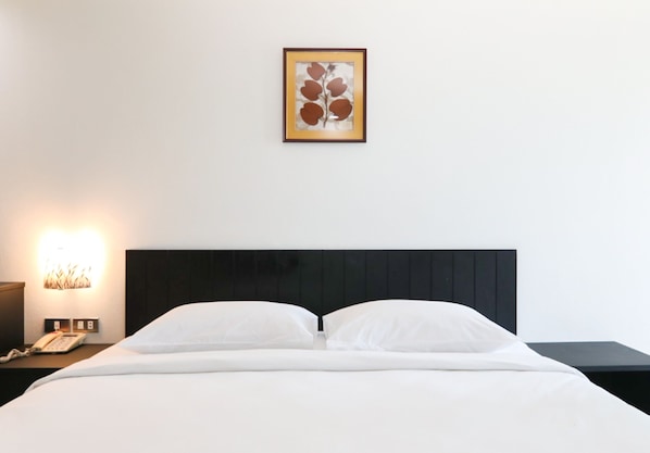 Habitación individual estándar | Caja de seguridad en la habitación, escritorio y ropa de cama 