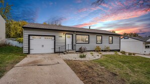 A single-story house with a garage, a front door, and a small porch area. - Five Star Flip- Bright & Renovated 3BR/2BA (Sioux Falls)