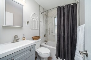 Bathtub, hair dryer, towels, soap