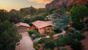 A residential area with houses surrounded by lush greenery and mountains in the background. - Sedona Serene Retreat, Amazing Views & Hot Tub! Walk to Hiking Trails!  (Sedona)