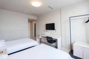 A hotel room with two beds, a desk, a chair, a TV, and a wardrobe. - Jinjiang (Gaoyou Haichao East Road) (Gaoyou)