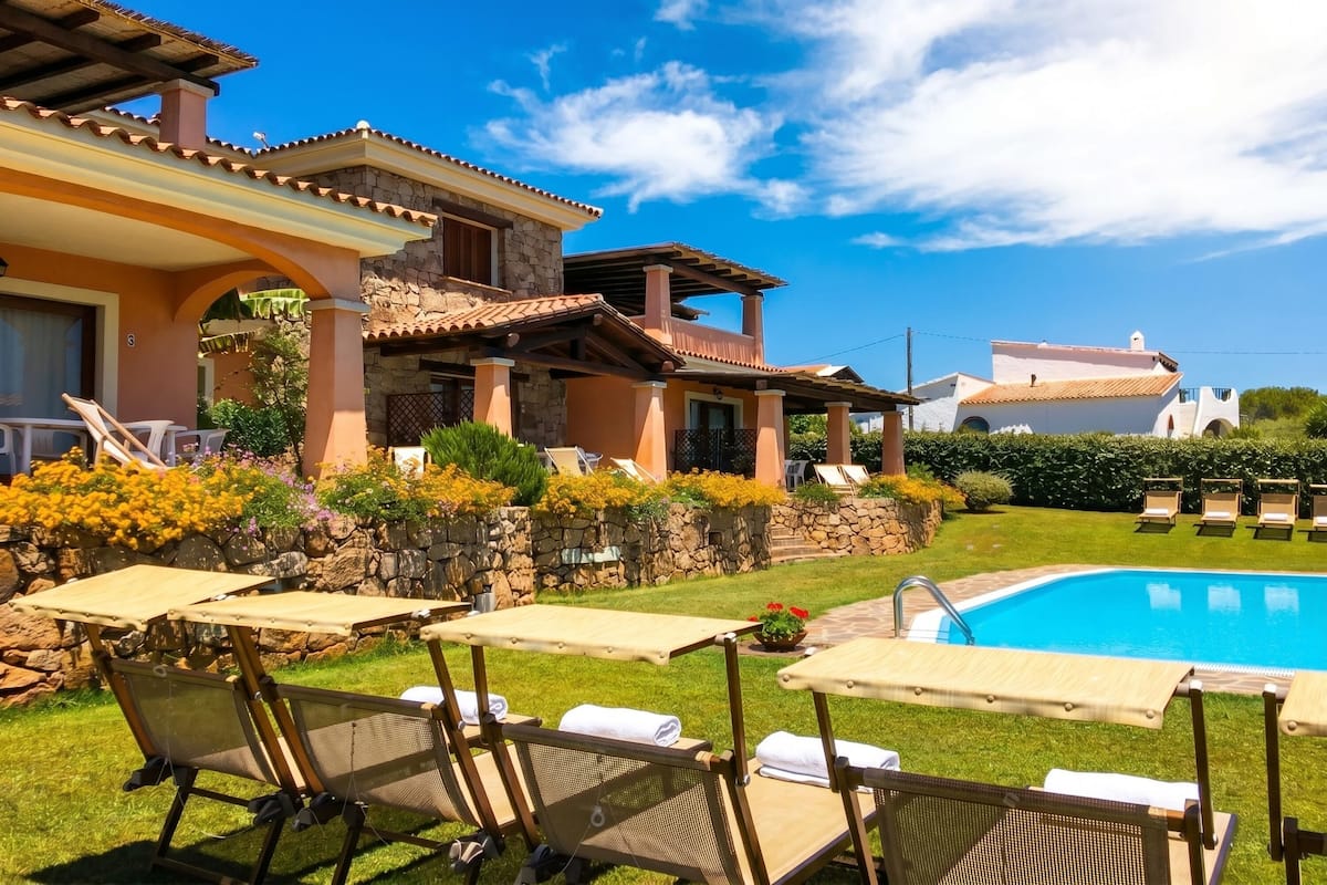 A poolside area with lounge chairs and a swimming pool.