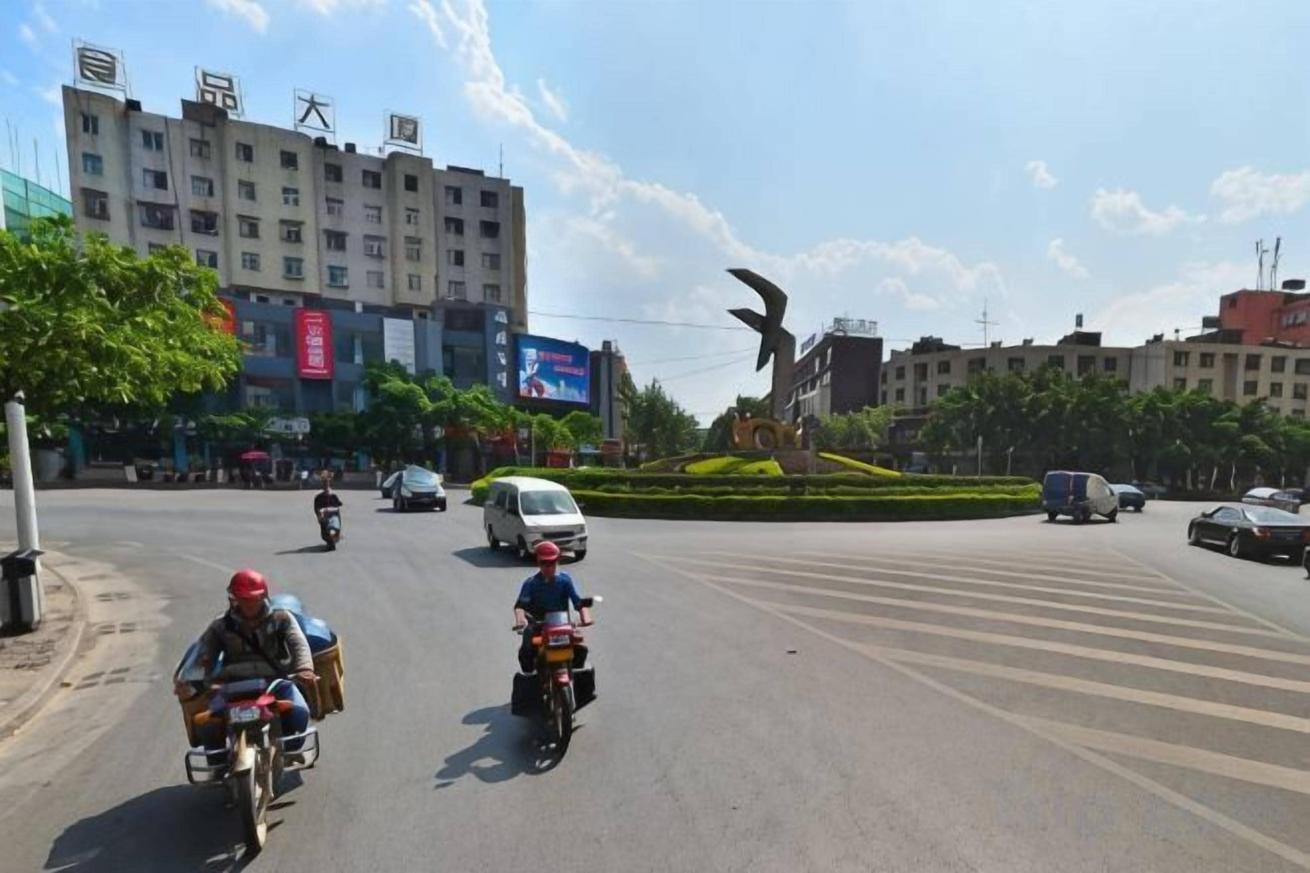 A street scene with vehicles and buildings.