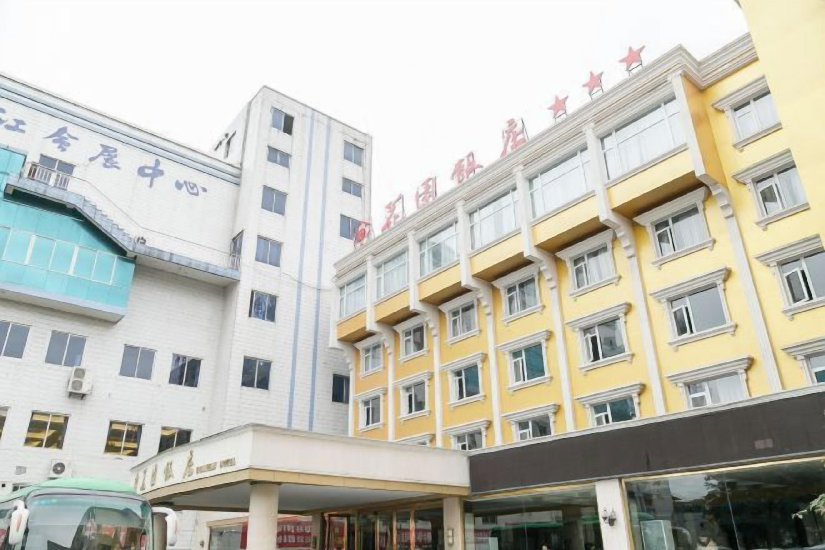 A multi-story building with a flat facade, several windows, and a visible entrance area.