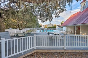 Enjoy a refreshing dip in the pool or relax in the covered seating area surrounded by a charming deck.