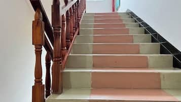 A staircase with wooden handrails and beige steps.